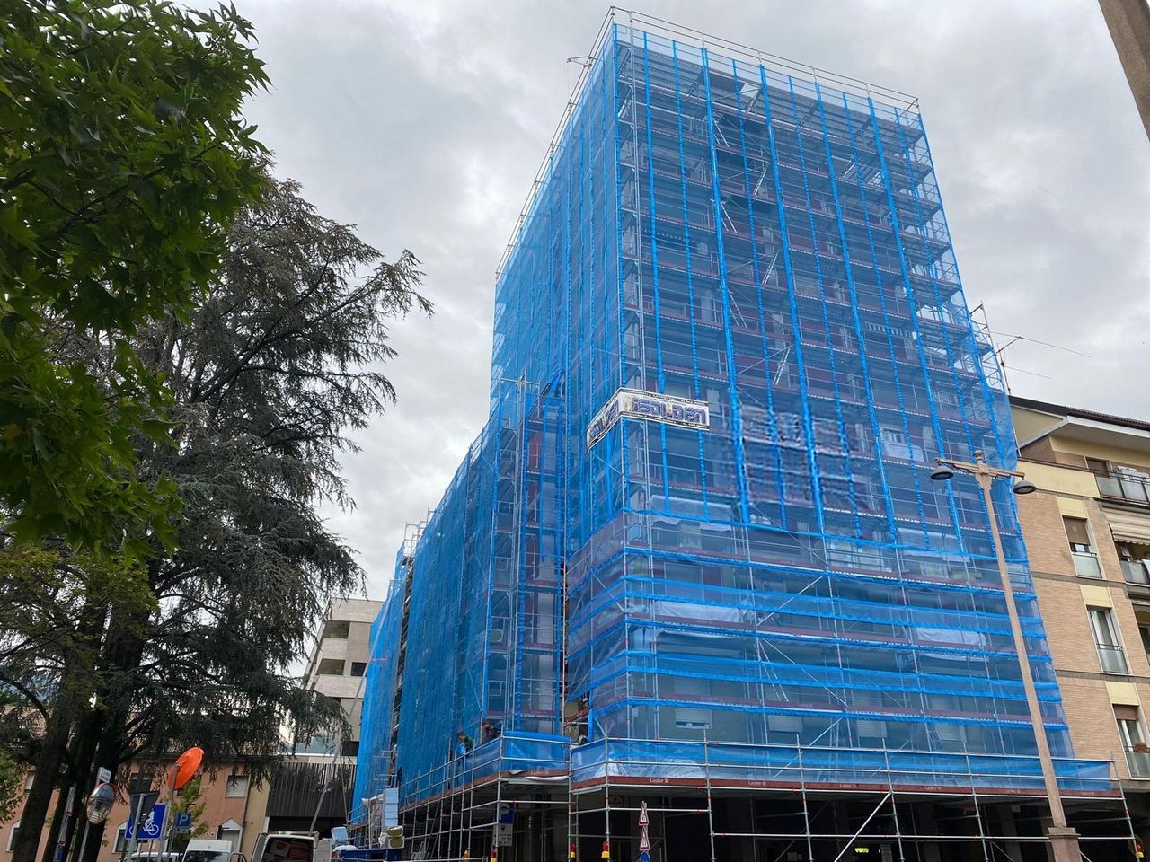 Scaffolding with protective sheeting on a multi-storey residential block